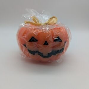 Orange Pumpkin Candle with Black Jack-o'-Lantern Face